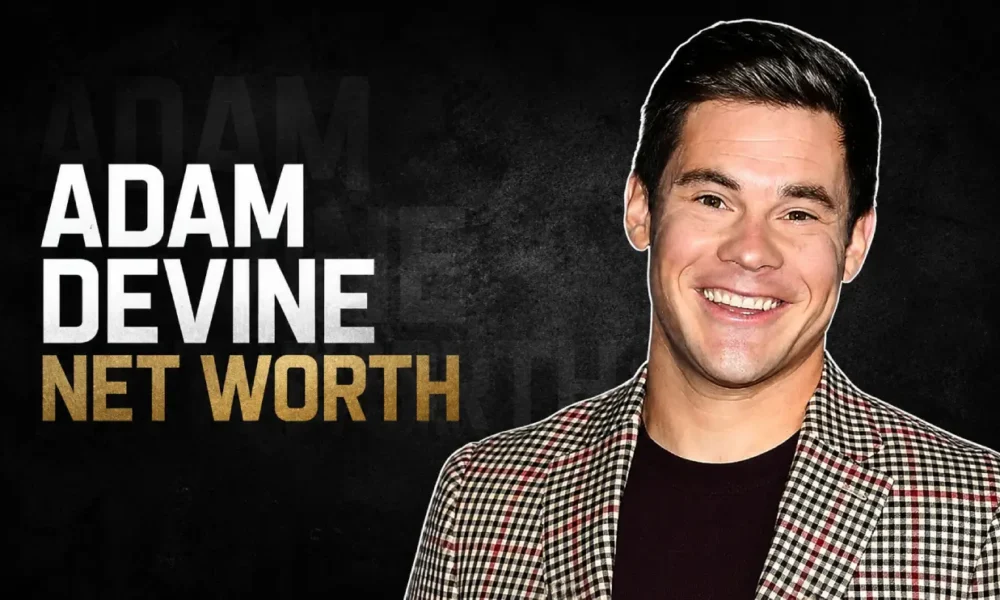 Adam Devine smiling in a checkered blazer