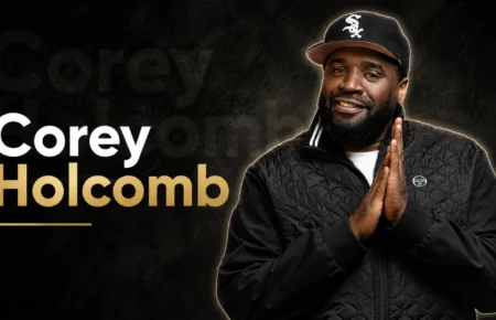 Corey Holcomb smiling during a studio photoshoot.