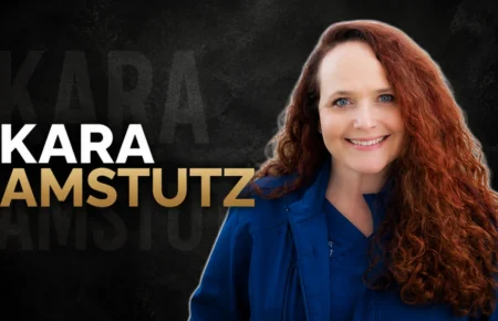 Kara Amstutz smiling in professional veterinary attire