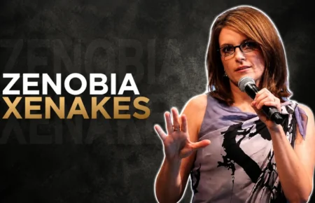 Zenobia Xenakes speaking on stage with a microphone
