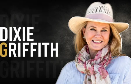 Dixie Griffith smiling in a hat and scarf