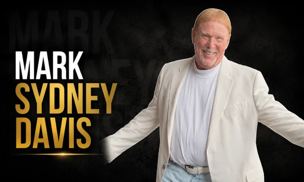Mark Sydney Davis, the adopted son of Sammy Davis Jr., smiling in a light-colored outfit.
