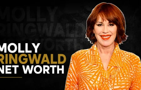 Molly Ringwald wearing an orange patterned blouse