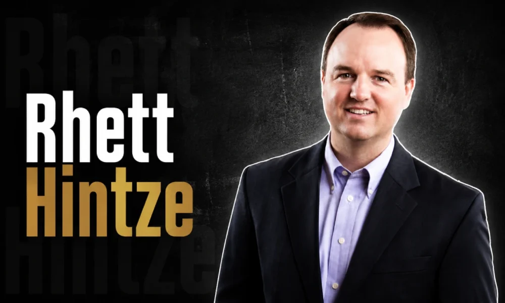 Rhett Hintze, business executive associated with StateSource, smiling in professional attire.