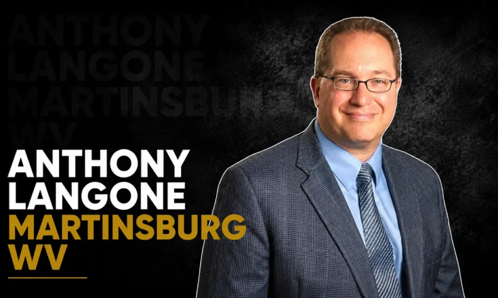 Anthony Langone wearing a suit and glasses