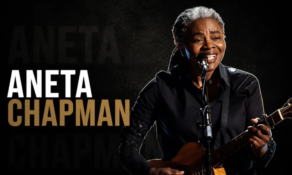 Aneta Chapman performing with a guitar