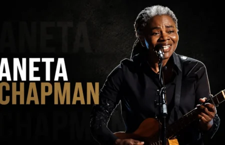 Aneta Chapman performing with a guitar