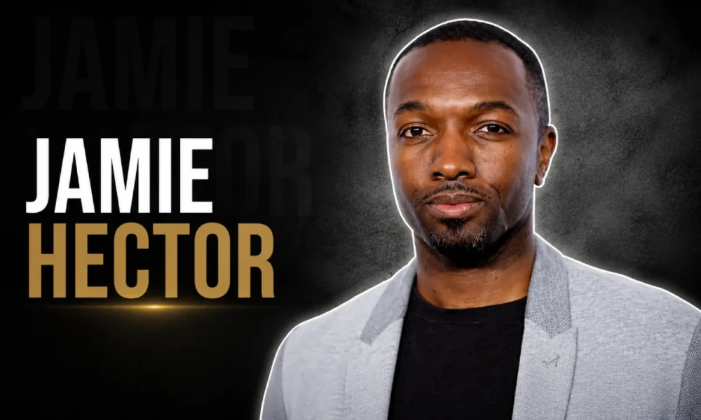 Jamie Hector in a light gray blazer