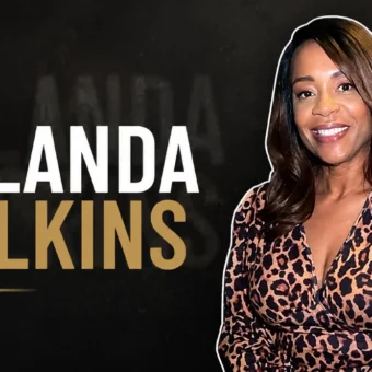 Yulanda Wilkins smiling while wearing a leopard print dress.