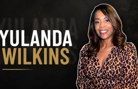 Yulanda Wilkins smiling while wearing a leopard print dress.